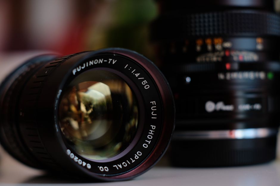 Detailed, close-up macro photograph showing the web-like pattern of mold and fungus growing inside a professional camera l...